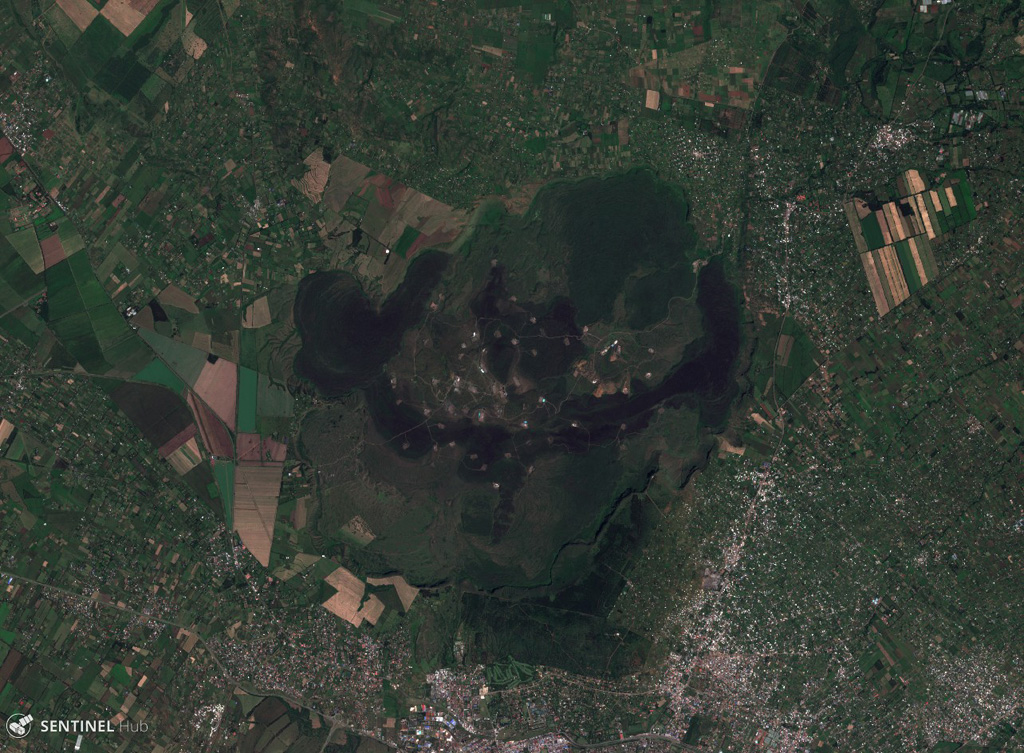 The Menengai shield volcano contains a roughly 8 x 12 km caldera with 300-m-high caldera walls, seen in this 28 November 2019 Sentinel-2 satellite image (N is at the top; this image is approximately 25 km across). Caldera formation occurred during two explosive eruptions, and since then there have been more than 70 events producing lava flows, pumice deposits, and scoria cones. The city of Nakuru lies at the bottom of the image, south of the caldera. Satellite image courtesy of Copernicus Sentinel Data, 2019.
