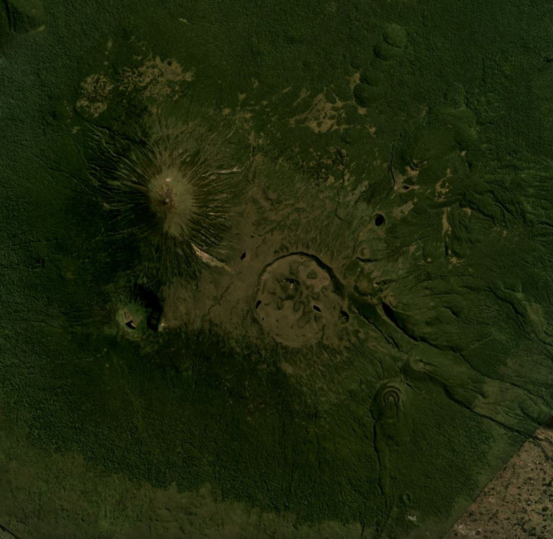 This June 2018 Planet Labs satellite image mosaic (N at the top) shows Karisimbi volcano of the Virunga volcanic field in Rwanda. The 1.5-km-wide Caldera Branca is seen near the center, with the summit to the NW and Mutango crater south of that. Extending SE of the caldera is a lava flow field with individual flows reaching 12 km in length. Satellite image courtesy of Planet Labs Inc., 2018 (https://www.planet.com/).