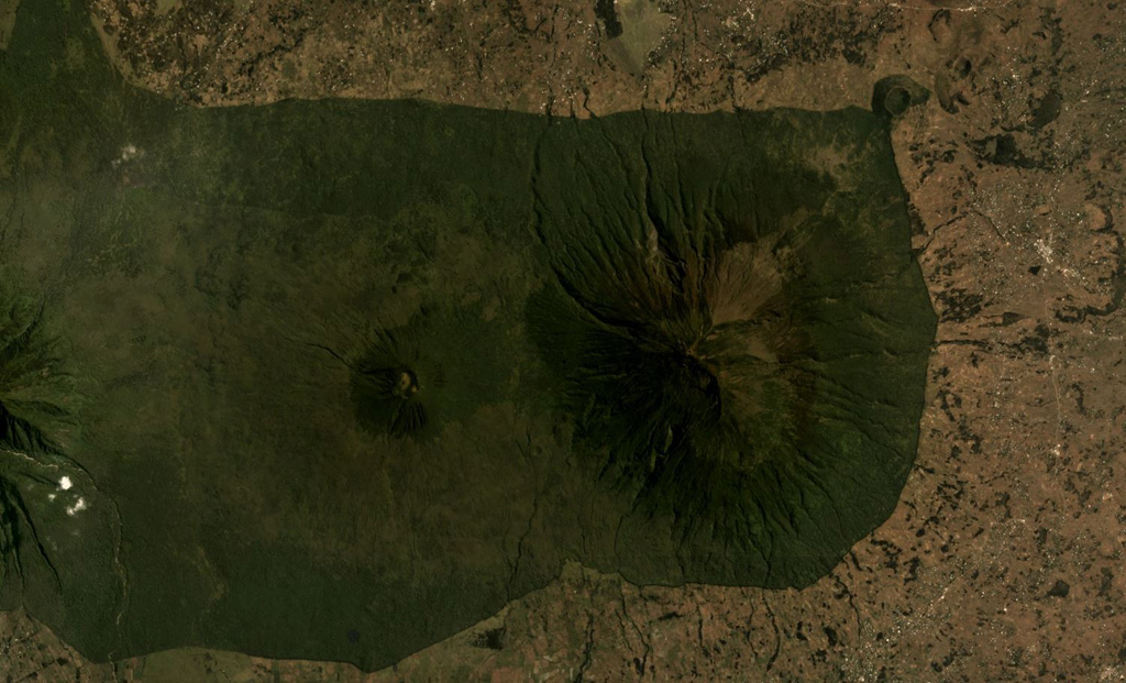 Muhavura is at the NE end of the Virunga volcanic range and is seen here in an August 2019 Planet Labs satellite image mosaic (N at the top). The summit is E of the image center, and W of that is the Gahinga flank cone. To the far W is the flank of Sabinyo. Satellite image courtesy of Planet Labs Inc., 2019 (https://www.planet.com/).