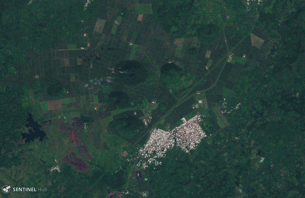 The Tombel Graben is a series of grabens that contain a monogenetic volcanic field consisting largely of scoria cones, maars, and lava flows, several of which are seen in this 13 November 2019 Sentinel-2 satellite image (N at the top). The town of Malinkam is seen here, and the larger Malinkam cone about 2 km SW is approximately 1 km wide. Satellite image courtesy of Copernicus Sentinel Data, 2019.