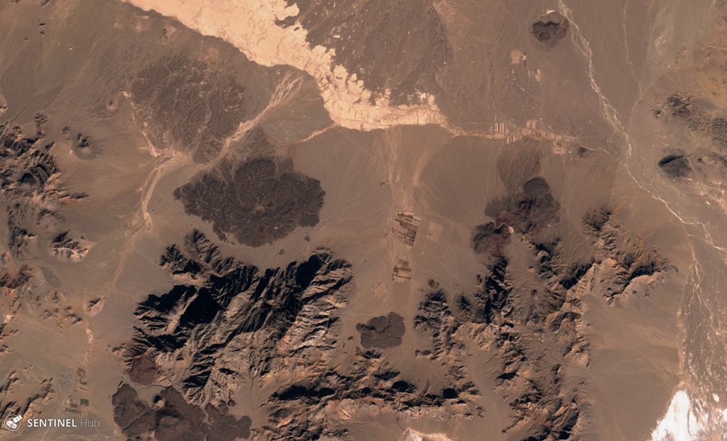 Several lava flows of the Kuh-e Nader volcanic field are visible here, located in the Nader Mountains between Taftan and Bazman volcanoes in SE Iran. Several lobate lava flow boundaries are apparent. This 3 December 2019 Sentinel-2 satellite image is approximately 18 km across (N at the top). Satellite image courtesy of Copernicus Sentinel Data, 2019.