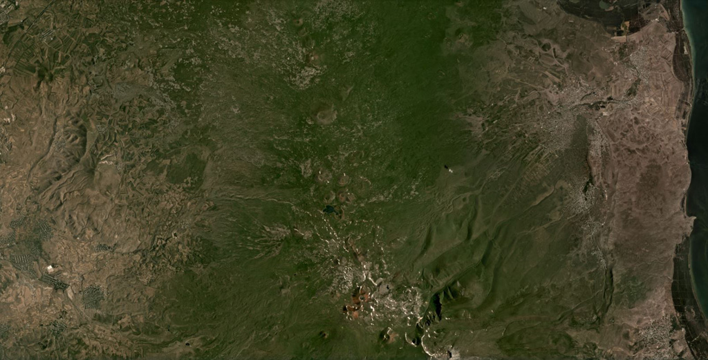 The Ghegam Volcanic Ridge can be seen through the center of this July 2020 Planet Labs satellite image monthly mosaic (N is at the top; this image is approximately 55 km across). Around 127 identified volcanic centers, including lava domes and cones, span an area 65 km long and 35 km wide in Armenia, west of Lake Sevan. Satellite image courtesy of Planet Labs Inc., 2020 (https://www.planet.com/).