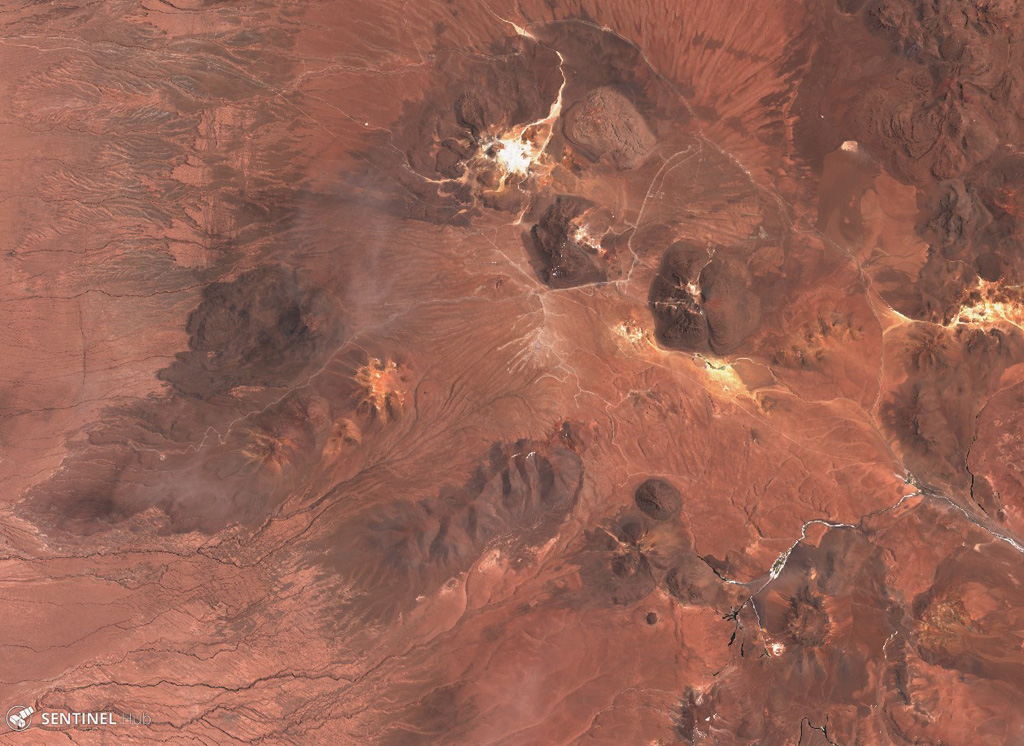 The Cerro Purico complex is shown in this 5 November 2019 Sentinel-2 satellite image (N is at the top; the image is approximately 43 km across). The dome containing white material at the top is Cerro Toco, then towards the SW is Cerro Chajnantor and Cerro Chascón. The dark lava flow to the W was erupted from Cerro Negro, then towards the SW is Cerros de Macon, Cerro Putas, and Cerro Aspero, and the edifice with the crater in the SW corner is Alitar. Satellite image courtesy of Copernicus Sentinel Data, 2019.