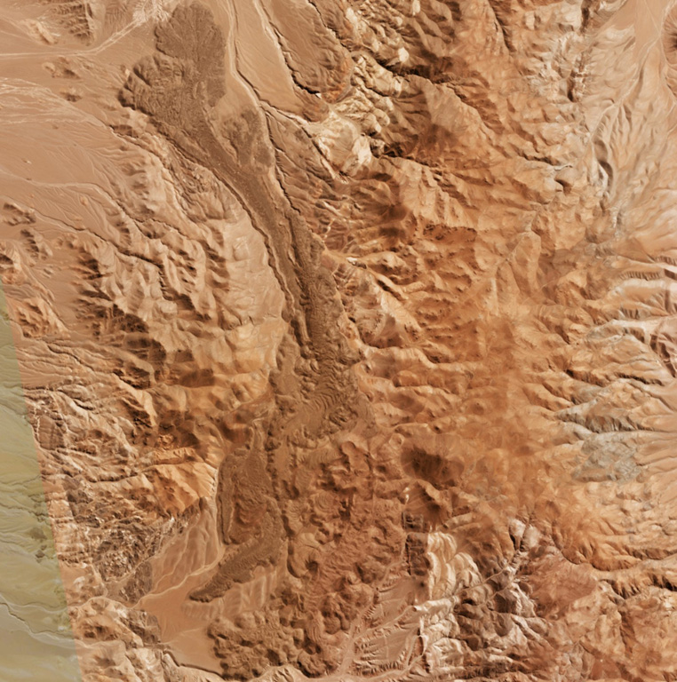 An elongated lava flow field at La Negrillar is down the center of this 28 April 2019 Planet Scope satellite image (N is at the top; this image is approximately 17 km across). A scoria cone with a crater that opens towards the SE is visible below the center of the image. The field is located along the SW margin of the Atacama basin, W of Socompa volcano. Satellite image courtesy of Planet Labs Inc., 2019 (https://www.planet.com/).