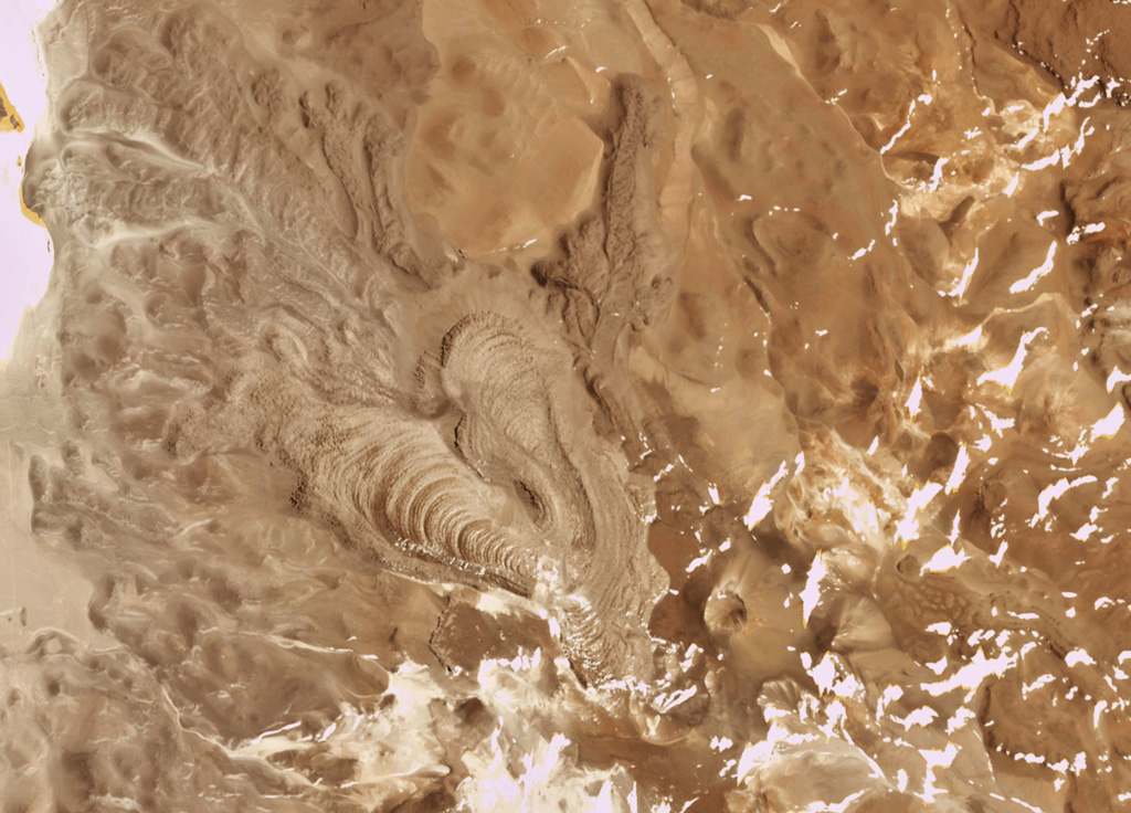 The Cerro Bayo volcanic complex is along the Chile-Argentina border east of the Salar de Gorbea and is shown in this 21 October 2019 Planet Scope satellite image (N is at the top; the image is approximately 11.5 km across). A 430-m-diameter crater is visible at the summit of a scoria cone, and to the W are lobate lava flows with levees and pressure ridges. Satellite image courtesy of Planet Labs Inc., 2019 (https://www.planet.com/).