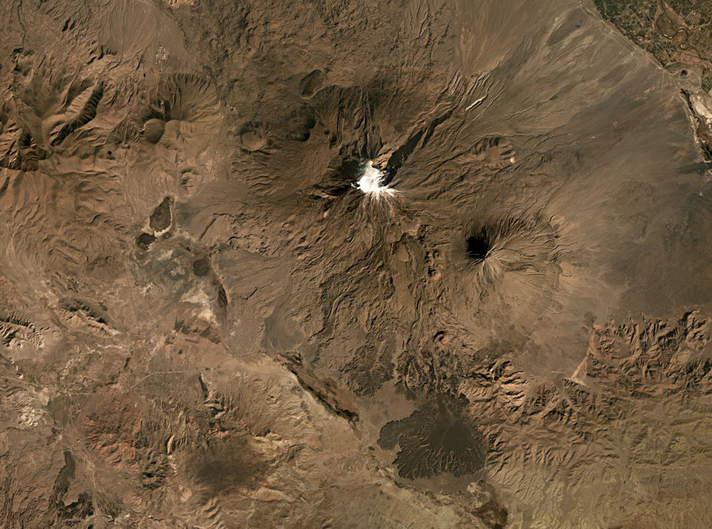 Mount Ararat, or the Ağri Daği volcanic complex, in Turkey has two main edifices, Buyuk Ağrı near the center of this image and the smaller Kucuk Ağri to the SE, both seen in this October 2019 Planet Labs satellite image monthly mosaic (N is at the top; this image is approximately 40 km across). Large recent lava flows form the darker areas to the S of the main glaciated cone. Satellite image courtesy of Planet Labs Inc., 2019 (https://www.planet.com/).