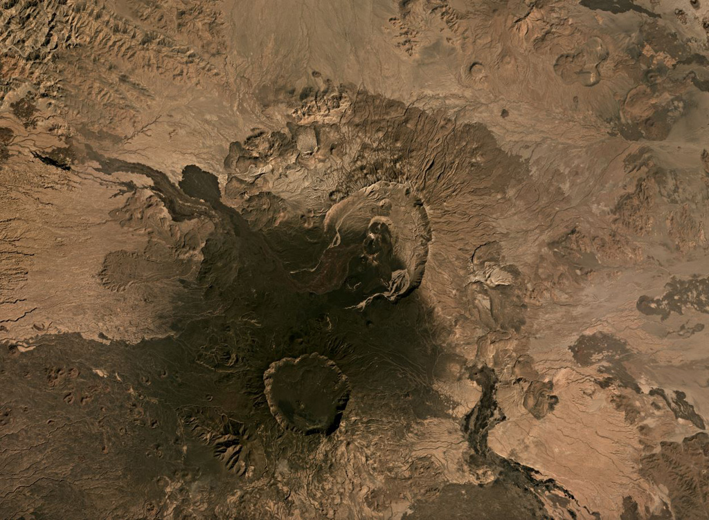 This November 2019 Planet Labs satellite image monthly mosaic shows several calderas and lava flows, with Nabro in the center and Mallahle below it within the Bidu Volcanic Complex (N is at the top). The 8-km-wide Nabro summit caldera opens towards the S, and the darker lava flow towards the NWW was erupted in 2011. Satellite image courtesy of Planet Labs Inc., 2019 (https://www.planet.com/).