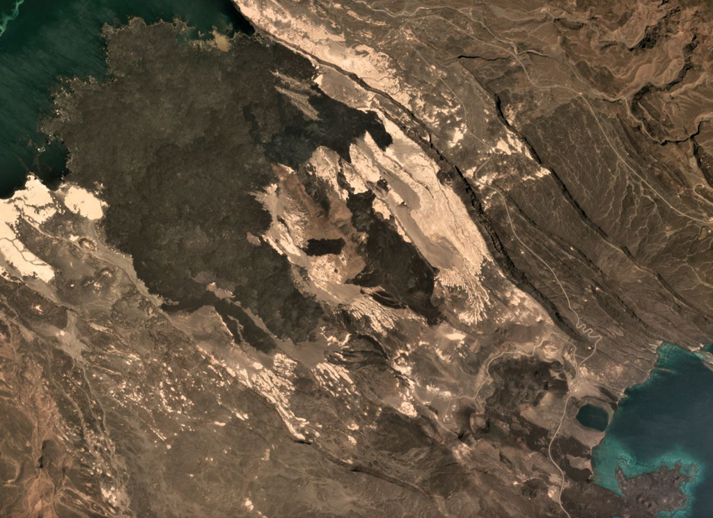The Ardoukôba Rift is in Djibouti at the NW end of Lake Ghoubet (lower right) and is shown in this October 2019 Planet Labs satellite image monthly mosaic (N is at the top; this image is approximately 11 km across). It contains lava flows from scoria and spatter cones, with recent deposits erupted in 1978. Satellite image courtesy of Planet Labs Inc., 2019 (https://www.planet.com/).