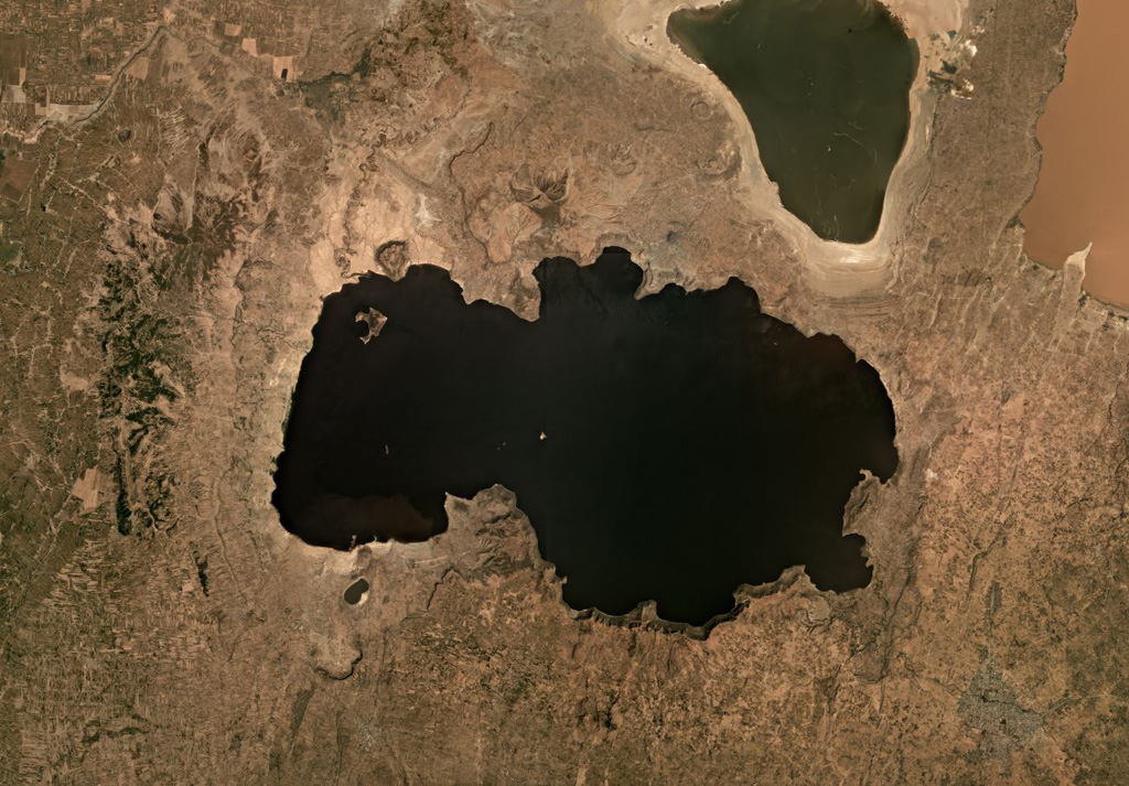 The eastern side of Lake Shala formed within the 17-km-wide O'a caldera, shown in this November 2019 satellite image monthly mosaic (N is at the top; this image is approximately 50 km across). The western part of the lake formed in a fault-controlled basin. The lake-filled Chitu maar is near the SW side of the Lake Shala. Satellite image courtesy of Planet Labs Inc., 2019 (https://www.planet.com/).