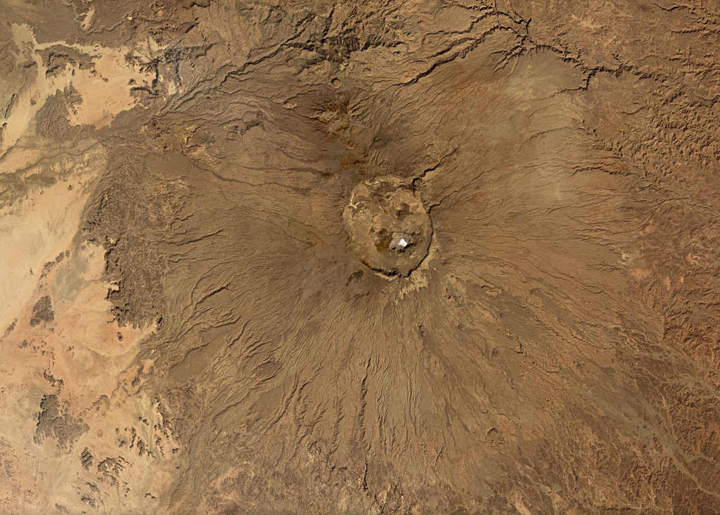 Emi Koussi is the largest volcano of the Tibesti massif in Chad, with a diameter of 60-70 km and a summit crater approximately 13.5 x 11 km in size, seen in this this November 2019 Planet Labs satellite image monthly mosaic (N is at the top; this image is approximately 92 km across). Smaller cones and vents can be seen within the caldera and on the flanks. Satellite image courtesy of Planet Labs Inc., 2019 (https://www.planet.com/).
