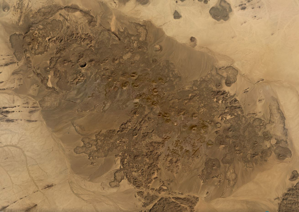 The 480 km2 Bayuda Volcanic Field in Sudan contains around 70 small volcanic centers including at least 53 scoria cones and 15 maar craters, shown in this November 2019 Planet Labs satellite image monthly mosaic (N is at the top; this image is approximately 46 km across). The field was partly constructed over Precambrian and Paleozoic granite, which form darker areas to the SE. Satellite image courtesy of Planet Labs Inc., 2019 (https://www.planet.com/).