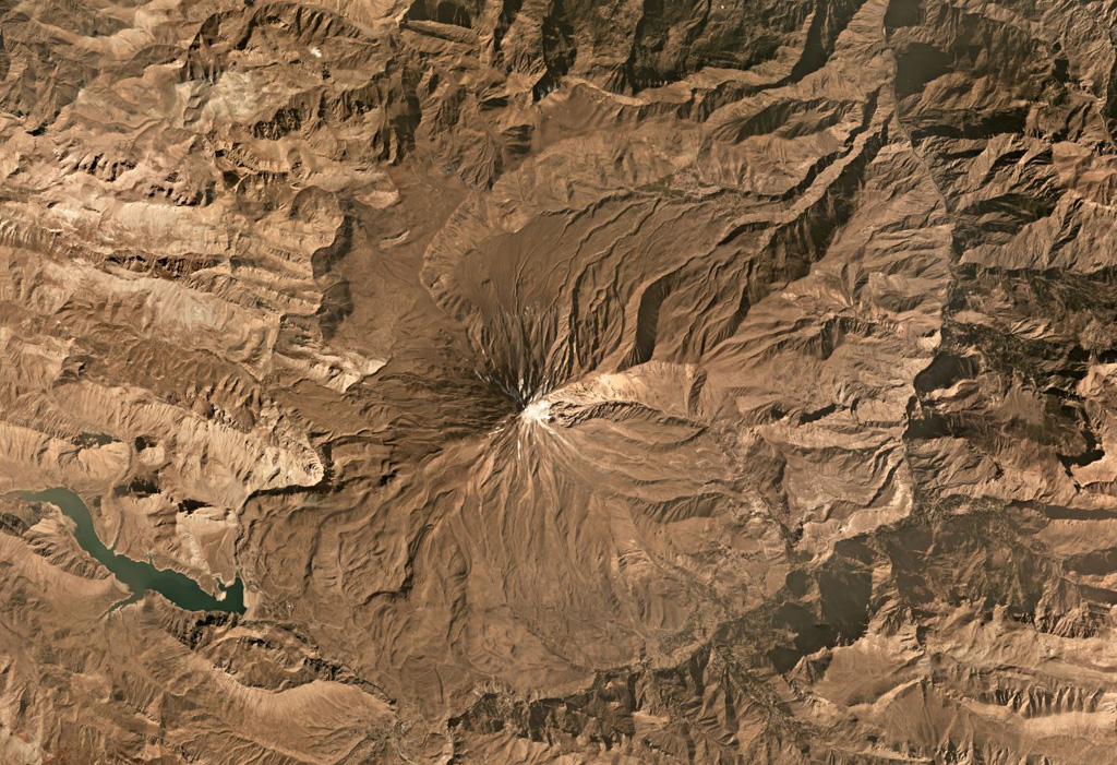 Damavand is largely composed of pyroclastic flow deposits, tephra, and radial lava flows that have erupted mostly from summit vents to form the steep flanks. The summit is near the center of this October 2019 Planet Labs satellite image monthly mosaic (N is at the top; this image is approximately 40 km across). The current cone has formed over the remains of an older cone. Satellite image courtesy of Planet Labs Inc., 2019 (https://www.planet.com/).