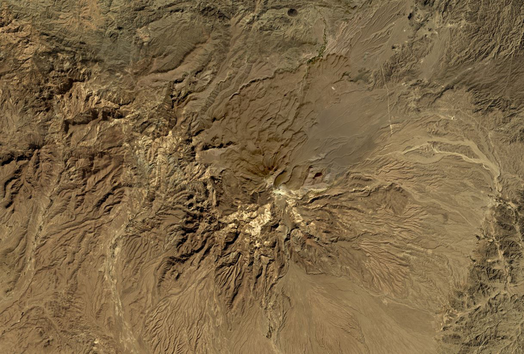 Taftan volcano in SE Iran has extensively eroded flanks composed of lava flows, pyroclastic flows, and ignimbrite deposits, shown in this October 2019 Planet Labs satellite image monthly mosaic (N is at the top; this image is approximately 42 km across). It has two main edifices, Narkuh and Matherkuh, and geothermal activity continues in the summit region. Satellite image courtesy of Planet Labs Inc., 2019 (https://www.planet.com/).