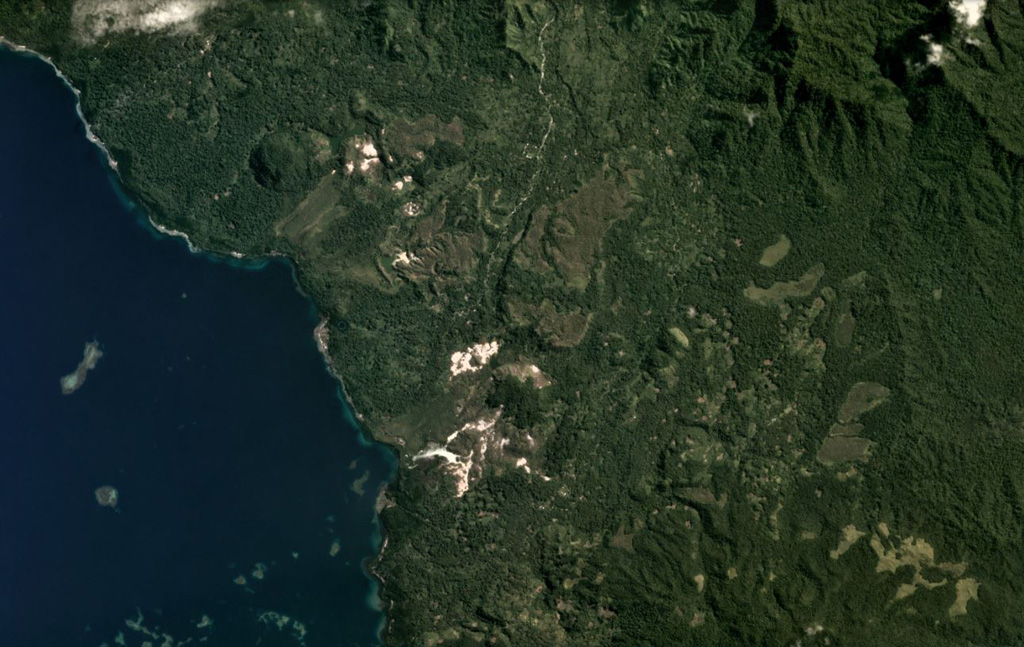 The Iamalele volcanic center on Fergusson Island is an active geothermal area (the white zones) seen in this May 2020 Planet Labs satellite image monthly mosaic (N is at the top; image is approximately 14 km across). The field contains lava domes and an ignimbrite deposit possibly related to caldera collapse. Satellite image courtesy of Planet Labs Inc., 2020 (https://www.planet.com/).