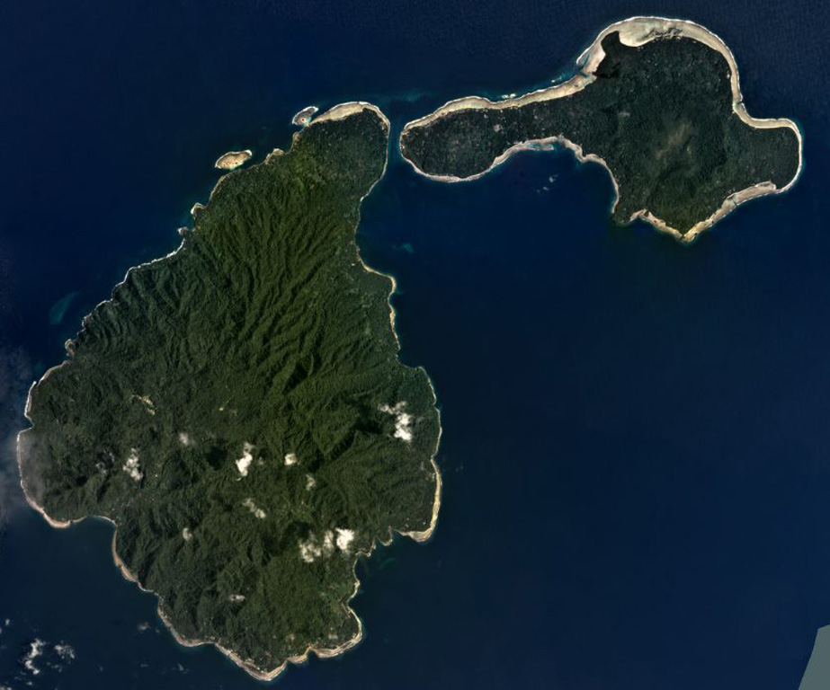 Ambitle Island is on the left and Babase Island is to the upper right in this February 2020 Planet Labs satellite image monthly mosaic (N is at the top; this image is approximately 21 km across). The 900 x 550 m Ambitle crater is near the center of the larger island and formed within a flank collapse scarp. Lava domes produced block-and-ash flow deposits and lava flows are also present. Satellite image courtesy of Planet Labs Inc., 2020 (https://www.planet.com/).