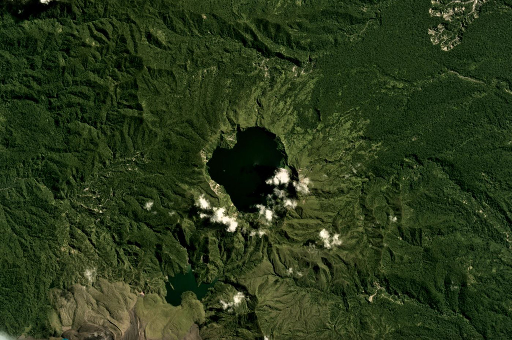 Billy Mitchell has produced some of the largest Holocene eruptions in Papua New Guinea, including the activity that produced the caldera in the center of this May 2018 Planet Labs satellite image monthly mosaic (N is at the top; this image is approximately 13 km across). Large eruptions around 900 and 370 years ago emplaced pyroclastic-flow and tephra deposits that reach 25 km away. Lava flows on the flanks of Bagana are to the lower left. Satellite image courtesy of Planet Labs Inc., 2018 (https://www.planet.com/).