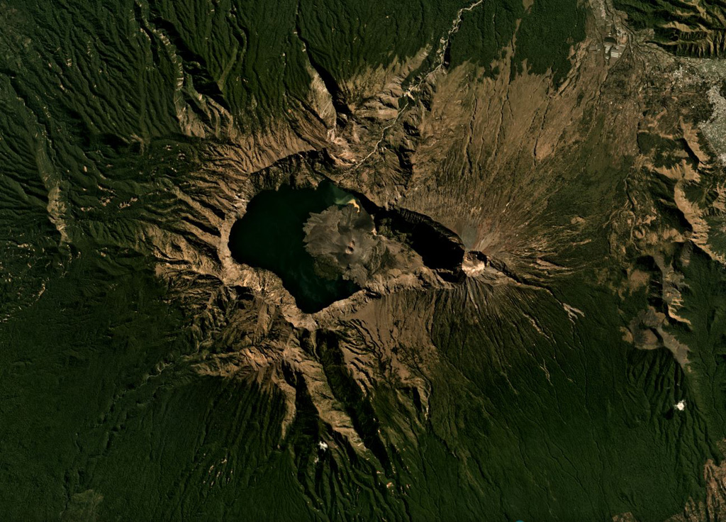 A lake partly fills the Segara Anak caldera (6 x 8.5 km wide, 800 m deep) of Rinjani volcano, shown here in this July 2019 Planet Labs satellite image monthly mosaic (N is at the top). The caldera formed during the 1257 eruption of Samalas volcano, the prior edifice. Barujari cone has formed within the caldera through a series of lava flow-producing eruptions. A roughly 1-km-wide crater is at the summit along the eastern side of the caldera. Satellite image courtesy of Planet Labs Inc., 2019 (https://www.planet.com/).