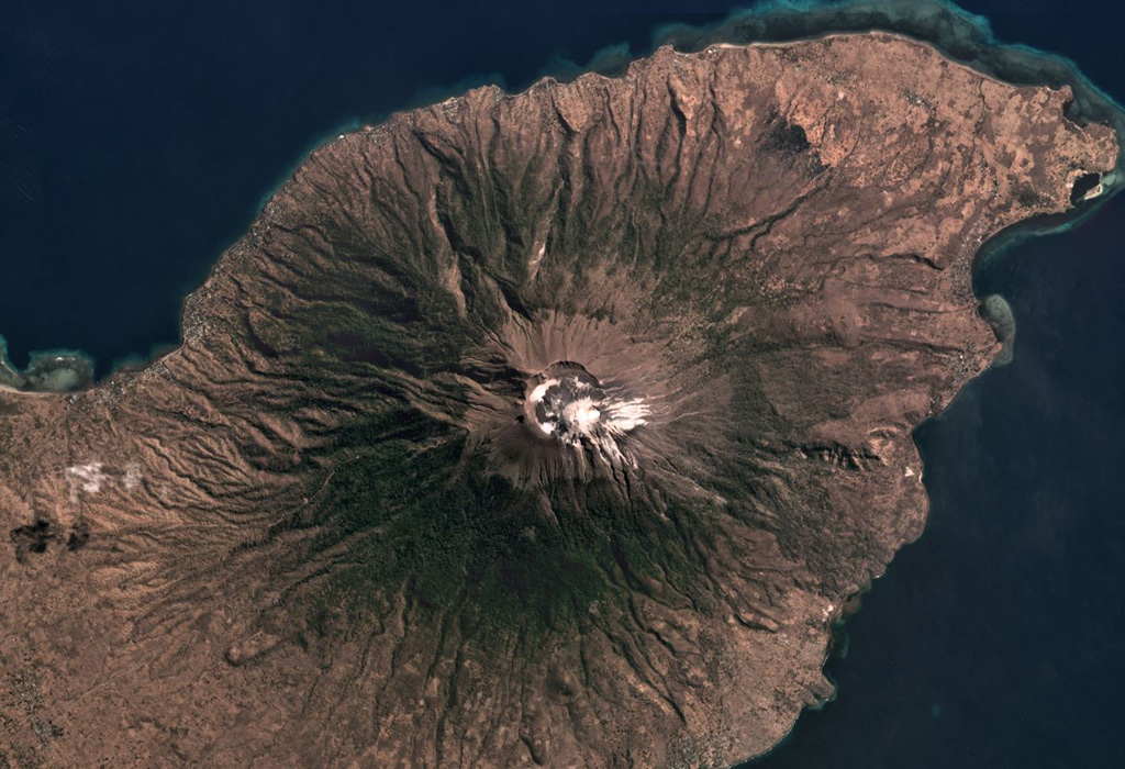 The approximately 800-m-diameter Lewotolo summit crater is in the center of this July 2019 Planet Labs satellite image monthly mosaic (N is at the top). A smaller cone with a 100-m-wide crater has formed along the main crater rim. Lighter colored deposits are seen at the summit area and erosion has formed gullies down the flanks. Satellite image courtesy of Planet Labs Inc., 2019 (https://www.planet.com/).