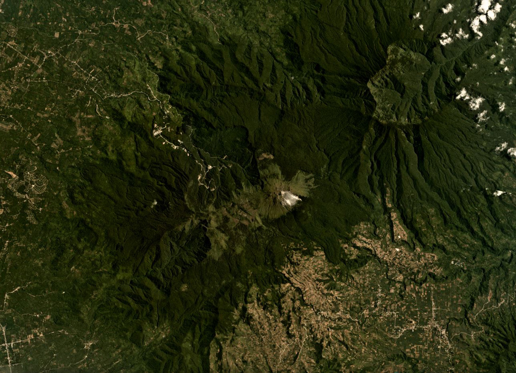 The Apo volcanic complex is composed of four edifices and several smaller cones, with the Apo dome being the youngest feature. The edifice is in the center of this August 2019 Planet Labs satellite image, which is approximately 24 km across. Geothermal activity continues in the area with a power plant within 3 km of the Apo dome. Satellite image courtesy of Planet Labs Inc., 2019 (https://www.planet.com/).