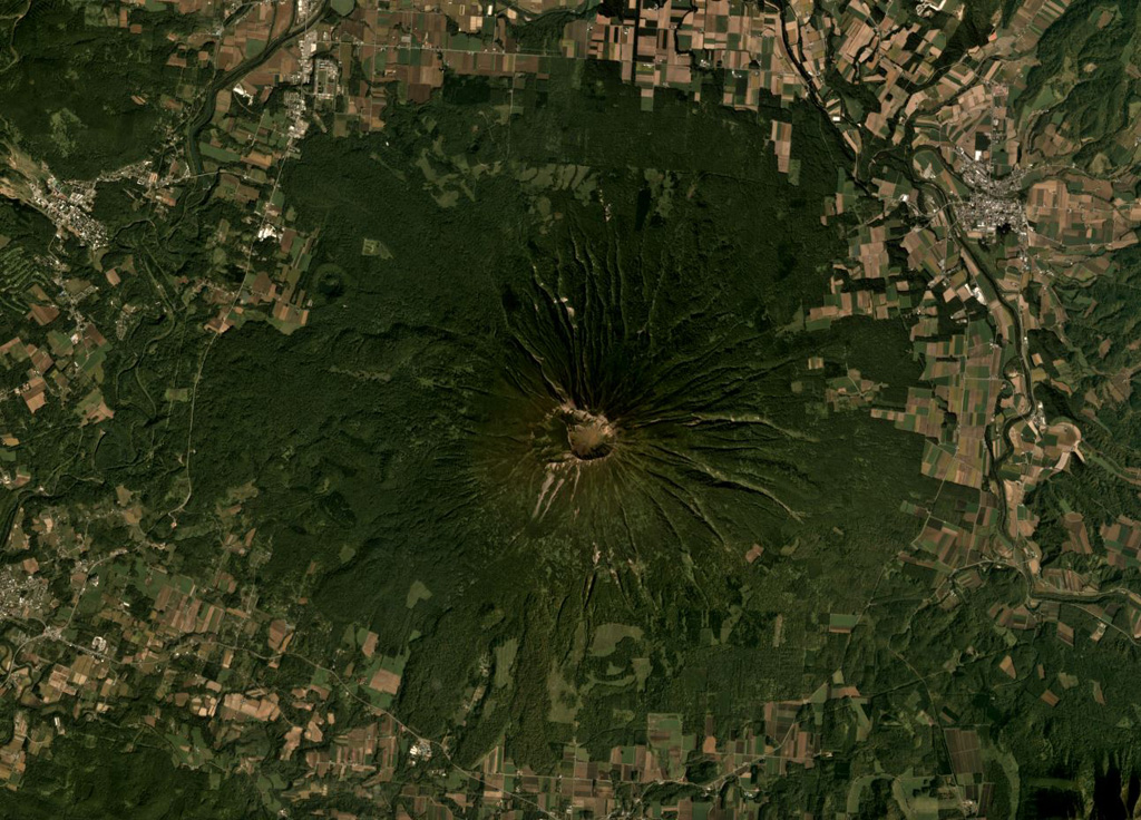 Yoteizan has a 700-800 m wide summit crater and smaller adjoining craters along its NW rim, shown in the center of this September 2019 Planet Labs satellite image monthly mosaic (N is at the top). Erosion has formed radial gullies down the flanks and the roughly 500-m-wide Hangetsu-ko crater is on the NW flank. Satellite image courtesy of Planet Labs Inc., 2019 (https://www.planet.com/).