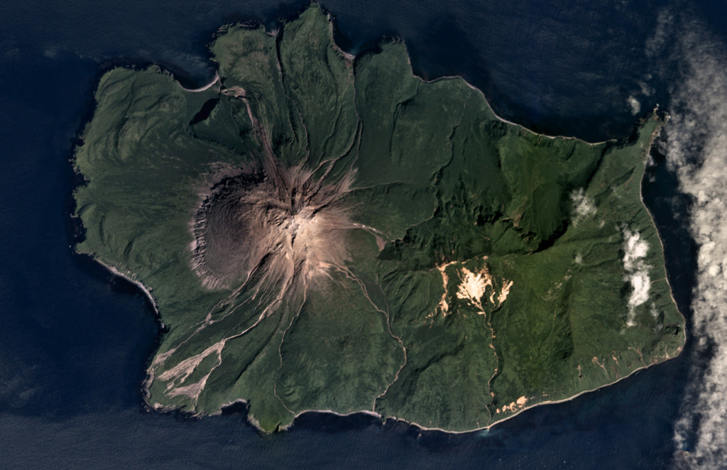 The 5.5 x 8 km Ekarma Island of the Kurile Islands is shown in this August 2017 Planet Labs satellite image monthly mosaic (N is at the top). The volcano forms the western side of the island, with flanks composed of lava flows out to 3 km in all directions and pyroclastic deposits between them. The summit crater has been filled with a lava dome that forms the summit of the cone. Satellite image courtesy of Planet Labs Inc., 2017 (https://www.planet.com/).