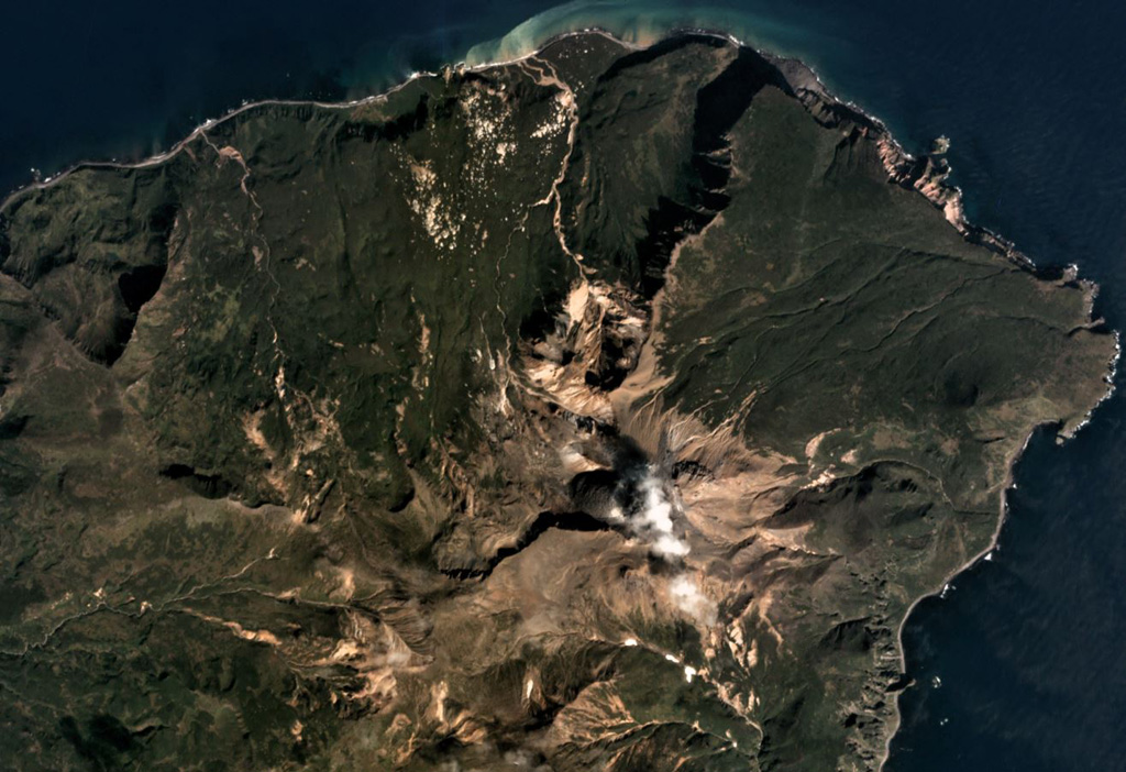Sinarka is the northernmost of two volcanoes forming Shiashkotan Island, shown in this September 2017 Planet Labs satellite image monthly mosaic (N is at the top; this image is approximately 8 km across). A large part of the NW flank has been removed by landslides and/or explosions, and a wide lava flow has been emplaced within the scarp. A lava dome has filled the summit crater, and another dome has formed 1.5 km SW. The current edifice has filled a previous caldera. Satellite image courtesy of Planet Labs Inc., 2017 (https://www.planet.com/).