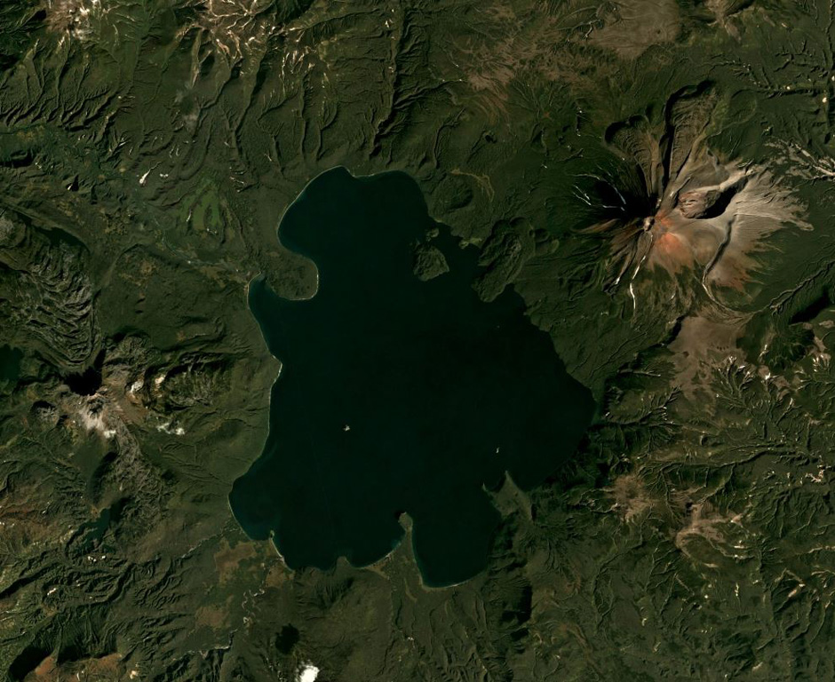 The Kurile Lake caldera, with Iliinsky volcano to the NE of the lake and Diky Greben to the W, is shown in this September 2019 Planet Labs satellite image monthly mosaic (N is at the top; this image is approximately 22 km across). The caldera formed during two large eruptions, with the more recent 7,600 14C yr BP eruption being one of the largest Holocene eruptions around the world. Surrounding the lake are the resulting ignimbrite deposits with some outcrops reaching 150 m thick. Satellite image courtesy of Planet Labs Inc., 2019 (https://www.planet.com/).