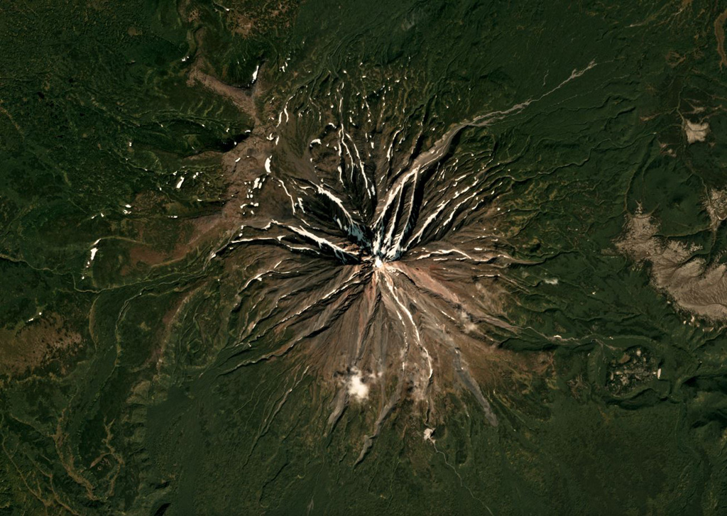 The current Opala cone formed along the northern rim of the 13 x 19 km Pleistocene caldera that formed during the largest eruption in Kamchatka in 50,000 years, shown in this September 2018 Planet Labs satellite image monthly mosaic (N is at the top; this image is approximately 15 km across). The circular feature on the SE flank is the ~1.3 x 2 km Baranii Amphitheater crater, which produced a large eruption in 1400 cal BP and was then filled with an obsidian dome. Satellite image courtesy of Planet Labs Inc., 2018 (https://www.planet.com/).
