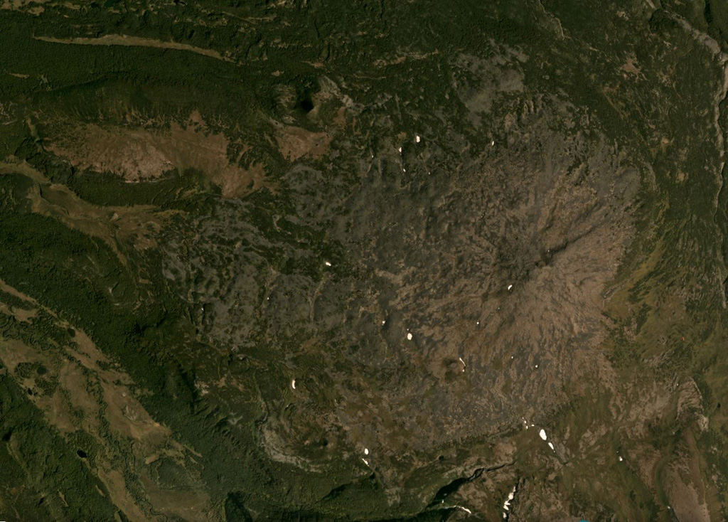 The summit of the broad Plosky volcano is east of the center of this September 2018 Planet Labs satellite image monthly mosaic (N is at the top; this image is approximately 15 km across), west of the northern Sredinny Range. Three scoria cones are preserved on the flanks, one on the NW flank produced a 1.5-km-long lava flow. Satellite image courtesy of Planet Labs Inc., 2019 (https://www.planet.com/).
