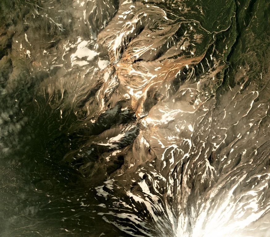 Aak volcano is in the center to the upper left of this August 2019 Planet Labs satellite image monthly mosaic (N is at the top; this image is approximately 13 km across). The edifice has two main eroded centers, Arik peak in the center and Pinachevsky in the NW section. The northern flanks of Koryaksky are to the lower right. Satellite image courtesy of Planet Labs Inc., 2019 (https://www.planet.com/).