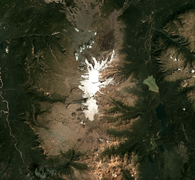 Mount Edziza is an approximately 30-km-long volcanic range that forms the northernmost edifice of the Mount Edziza volcanic complex, and is shown in this July 2018 Planet Labs satellite image monthly mosaic (N is at the top; this image is approximately 42 km across). Many eruptions occurred within ice and water, such as the Tennena cone on the western flank about two-thirds down the ice cap in this view, forming pillow lavas and hydrovolcanic clastic deposits. Satellite image courtesy of Planet Labs Inc., 2018 (https://www.planet.com/).