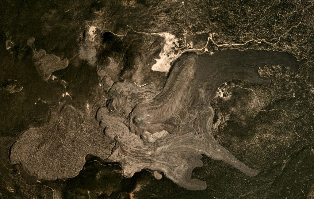 The Medicine Lake volcanic center covers around 2,200 km2, with recent lava flows shown in this August 2019 Planet Labs satellite image monthly mosaic (N is at the top; this image is approximately 10 km across). These lava flows at Big Glass Mountain erupted along the eastern caldera rim and ten lava domes formed in a NW trend, with one lava dome to the south. The western lava flow in this view flowed into the caldera and the eastern flows traveled down the flank. Satellite image courtesy of Planet Labs Inc., 2019 (https://www.planet.com/).