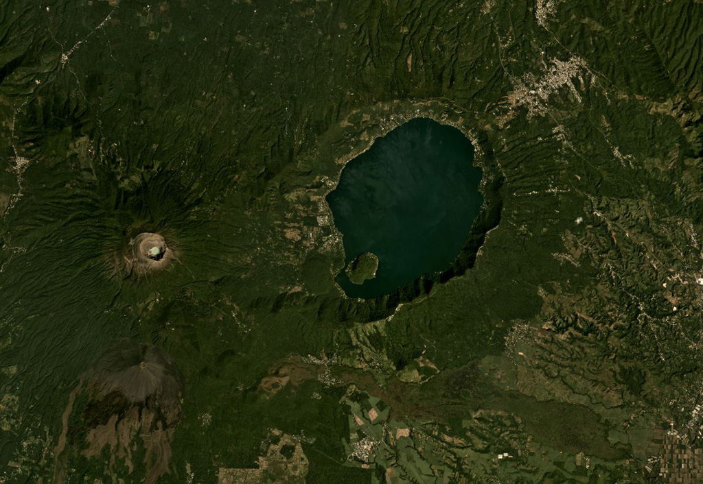 The 7 x 10 km lake-filled Coatepeque Caldera formed 72 ka and is shown in this November 2019 Planet Labs satellite image monthly mosaic (N is at the top; this image is approximately 25 km across). The western caldera rim formed on the Santa Maria eastern flank, and several lava domes formed in the SW area with Cerro Grande forming the island within the lake. Santa Ana with its blue-green crater lake and Izalco with the unvegetated slopes are W and SW, respectively. Satellite image courtesy of Planet Labs Inc., 2019 (https://www.planet.com/).