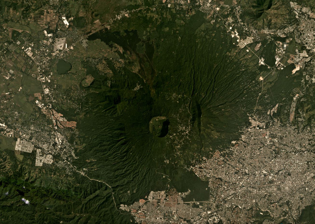 The 1.5-km-wide Boquerón crater of San Salvador is in the center of this November 2019 Planet Labs satellite image monthly mosaic (N is at the top), with the small Boqueroncito scoria cone in the center. A 6 x 4.5 km caldera formed around 40-30 ka and the current El Boquerón edifice was built within it. Recent activity was concentrated in the northern sector with lava flows emplaced on the N flank and within the crater. Satellite image courtesy of Planet Labs Inc., 2019 (https://www.planet.com/).