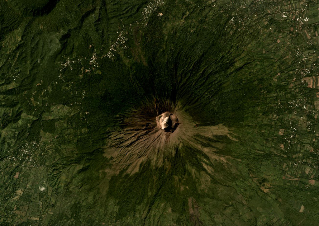 The summit crater of San Miguel, or Chaparrastique, volcano is in the center of this November 2019 Planet Labs satellite image monthly mosaic (N is at the top; this image is approximately 12 km across). Spatter and scoria cones have formed across the flanks during eruptions that emplaced lava flows up to 8 km from the vent. A flank cone that erupted a lava flow during the 1699 eruption is in the SW corner of this image (now vegetated) and the Chinameca caldera is in the NW corner. Satellite image courtesy of Planet Labs Inc., 2019 (https://www.planet.com/).