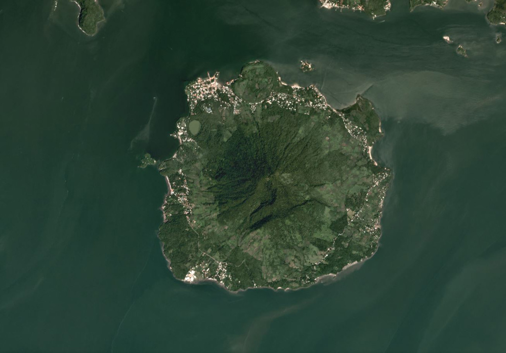 The 5.5-km-wide Isla del Tigre is located in the Gulf of Fonseca in Honduras, shown in this October 2019 Planet Labs satellite image monthly mosaic (N is at the top). There is a crater just below the summit on the southern flank as well as several other flank craters including El Vigía on the NW flank, just NE of the lake near the shore. Satellite image courtesy of Planet Labs Inc., 2019 (https://www.planet.com/).