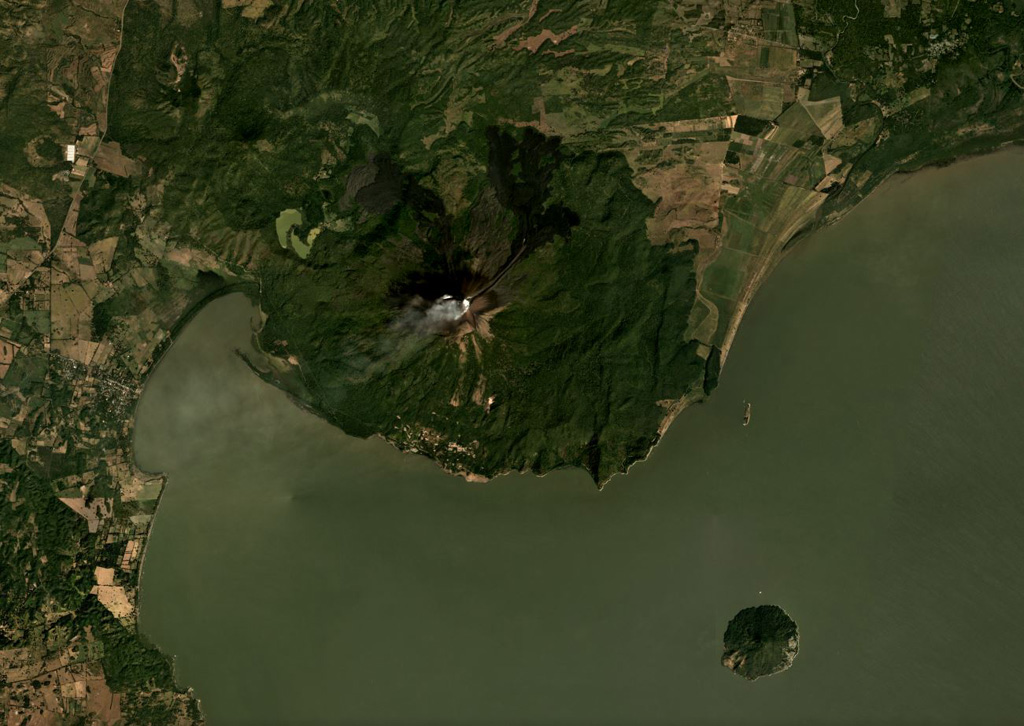Momotombo rises above the NW shore of Lake Managua and is in the center of this December 2019 Planet Labs satellite image monthly mosaic (N is at the top; this image is approximately 22 km across). Gas emissions emanating from the summit crater are dispersing to the SW. Lava has flowed into Monte Galán caldera on the NW flank towards Cerro Motoso, a cone on the NW caldera rim. The island to the SE is Volcán Momotombito and is part of the Momotombo complex. Lava flows in 2015 were emplaced down the NE flank on top of 1905 flows. Satellite image courtesy of Planet Labs Inc., 2019 (https://www.planet.com/).