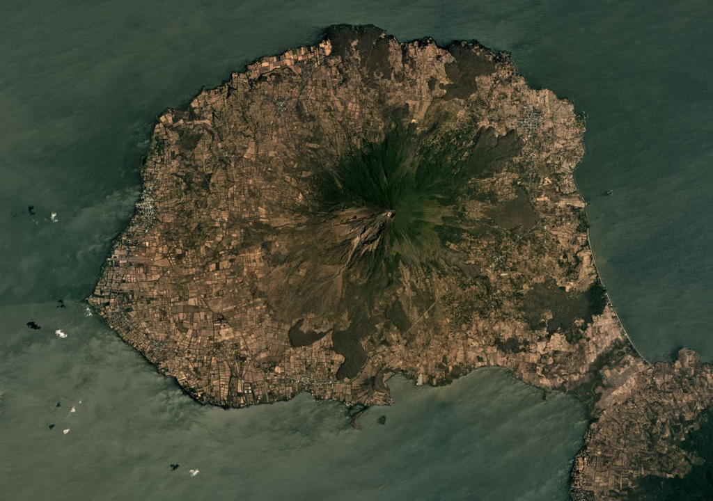 The steep Volcán Concepción forms the center of the northeastern portion of Ometepe Island in Lake Nicaragua, shown in this March 2019 Planet Labs satellite image monthly mosaic (N is at the top; this image is approximately 24 km across). Deformation occurs due to the volcano forming on top of unstable lake sediments of mud and clay. Spatter cones, cinder cones, lava domes, and maars have formed across the flanks. Maderas volcano forms the SE side of the island, out of view here. Satellite image courtesy of Planet Labs Inc., 2019 (https://www.planet.com/).