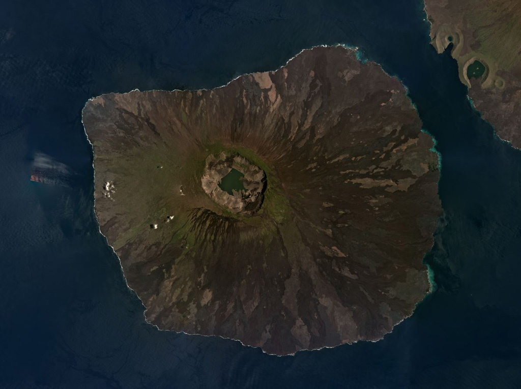 The Fernandina shield volcano in the Galapagos Islands has a roughly 5 x 6 km summit caldera seen in this March 2019 Planet Labs satellite image monthly mosaic (N is at the top). Frequent eruptions often produce circumferential fissures near the caldera as well as fissures on the lower flanks that feed lava flows, many of which are visible in a radial pattern around the flanks. Lava flows and collapse events around the caldera walls modify the caldera floor, which has a lake at the time of this image acquisition. Satellite image courtesy of Planet Labs Inc., 2019 (https://www.planet.com/).