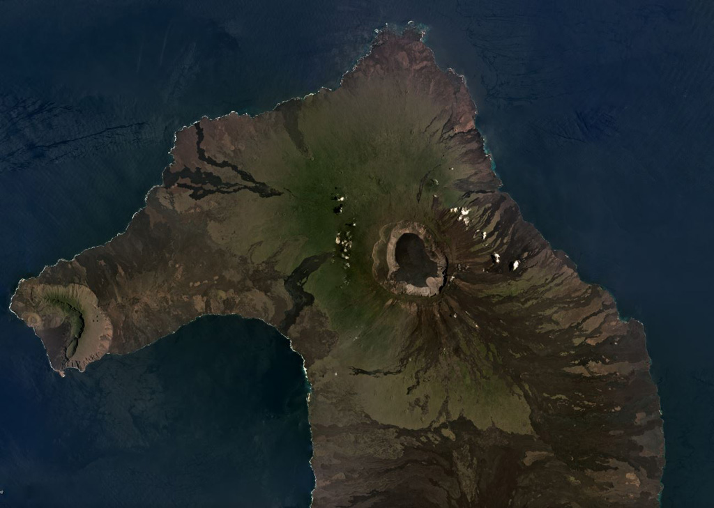 The 700-m-deep summit caldera of the Volcán Wolf shield volcano on Isabela Island, Galapagos Islands, is near the center of this March 2019 Planet Labs satellite image monthly mosaic (N is at the top; this image is approximately 50 km across). Lava flows have erupted from radial and circumferential fissures from the summit to the lower flanks. Volcán Ecuador and its East Rift zone forms the western peninsula, and the northern flank of Volcán Darwin is to the south. Satellite image courtesy of Planet Labs Inc., 2019 (https://www.planet.com/).