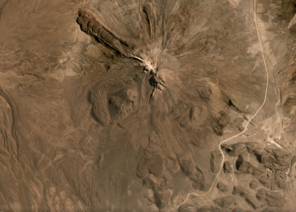 The flanks of Tata Sabaya have largely formed through the extrusion of lava domes and flows, with some lobate flows displaying pressure ridges and levees seen in this September 2019 Planet Labs satellite image monthly mosaic (N is at the top; this image is approximately 12 km across). The NW end of a hummocky roughly 300 km2 debris avalanche deposit is in the lower right corner of this image. The collapse scarp from the flank collapse that produced the deposit and opened toward the S has been subsequently filled by lava domes. Satellite image courtesy of Planet Labs Inc., 2019 (https://www.planet.com/).