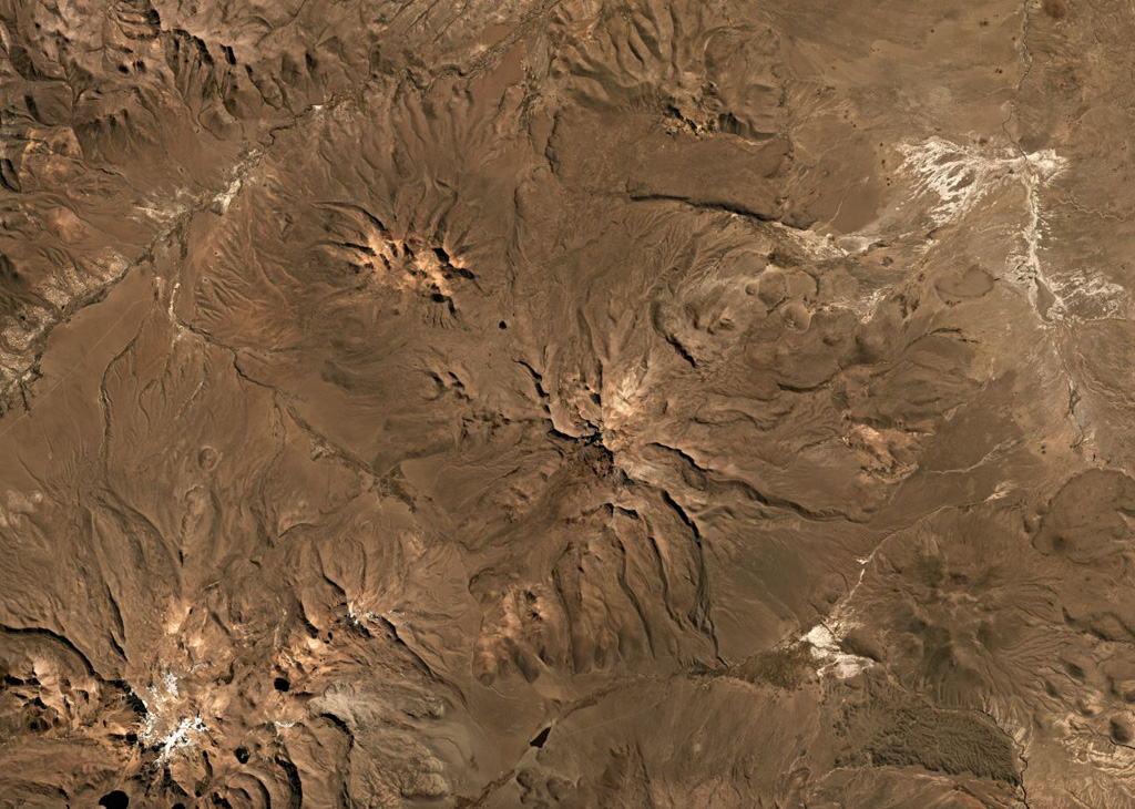 The Pleistocene Nevado Anallajsi volcanic complex in Bolivia is in the center of this Planet Labs satellite image monthly mosaic (N is at the top; this image is approximately 47 km across). The flanks have been deeply eroded and a remnant peak is in the center. At the time of this image acquisition there is no evidence for Holocene activity. Satellite image courtesy of Planet Labs Inc., 2019 (https://www.planet.com/).