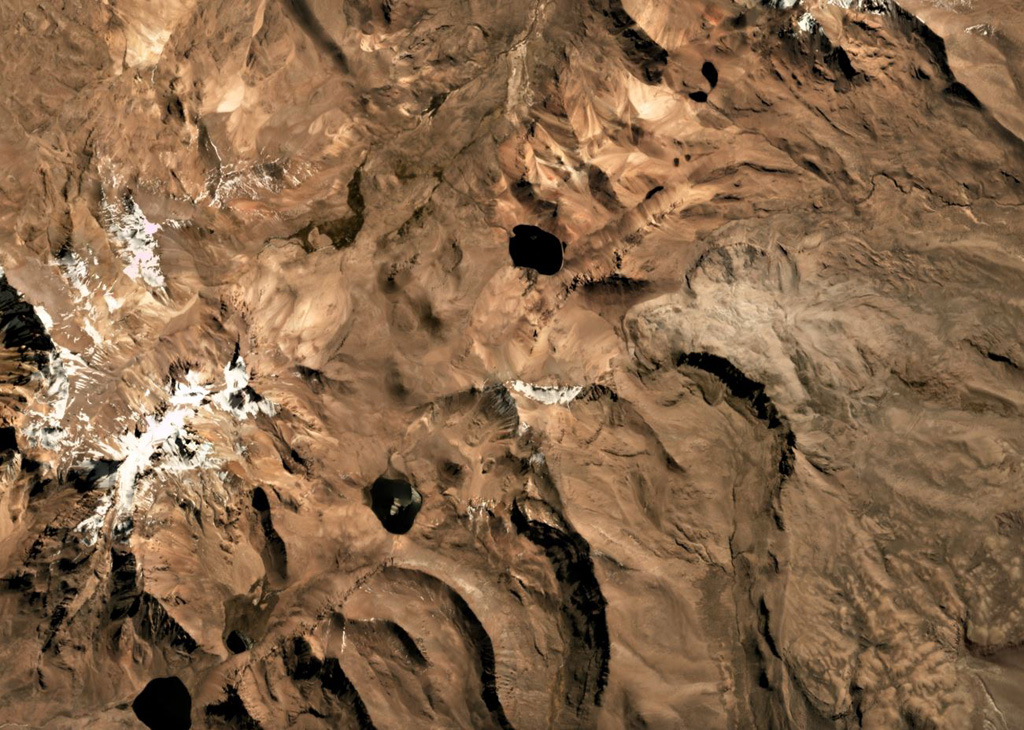 The Pleistocene Patilla Pata complex is in the center of this Planet Labs satellite image monthly mosaic (N is at the top; this image is approximately 15 km across). The edifice is deeply glacially eroded with a remnant peak in the center. Volcán Larancagua is to the SW. As of the time of image acquisition, there is no evidence for Holocene activity. Satellite image courtesy of Planet Labs Inc., 2019 (https://www.planet.com/).