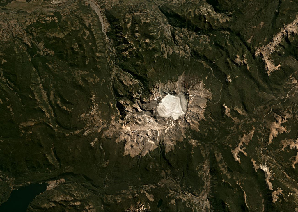 The 4-km-wide Sollipulli caldera contains over 500 m of ice (593 m measured in 2011) and overlaps an older caldera on the left in the center of this Planet Labs satellite image monthly mosaic (N is at the top; this image is approximately 40 km across). Around the caldera rim eruptions have formed lava flows, coulées, and domes, and on the SW rim is the 1-km-wide Alpehué crater. The Alpehué geyser field is on the SW flank near the summit area and recent scoria cones are on the NE flank. Satellite image courtesy of Planet Labs Inc., 2019 (https://www.planet.com/).