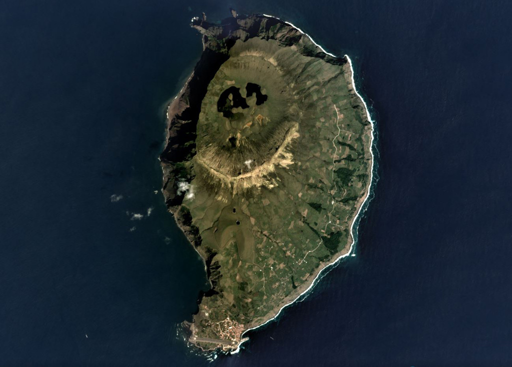 The 4 x 6 km Corvo island of the Azores archipelago is shown in this September 2019 Planet Labs satellite image monthly mosaic (N is at the top). The northern half of the island contains the O Caldeirão caldera and the western coast is composed of cliffs. A scoria cone that opens towards the S is visible below the center of this image, and several other cones and lava flows are across the lower half of the island. Satellite image courtesy of Planet Labs Inc., 2019 (https://www.planet.com/).