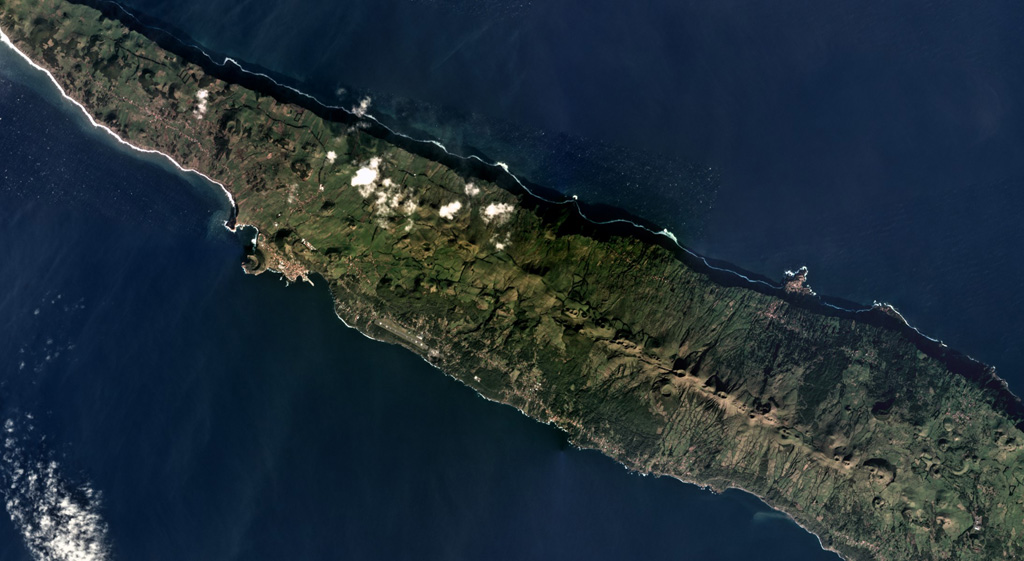 The 54-km-long and up to 6.5-km-wide San Jorge island is shown across this December 2018 Planet Labs satellite image monthly mosaic (N is at the top; this image is approximately 27 km across). The island has three main parts that compose the upper units across the island, with the Rosais Complex to the W, the Manadas Complex in the center, and the Topo complex in the E. The western two-thirds (mostly shown here) has fissure vents across the surface that produced lava flows and spatter ramparts. Satellite image courtesy of Planet Labs Inc., 2019 (https://www.planet.com/).
