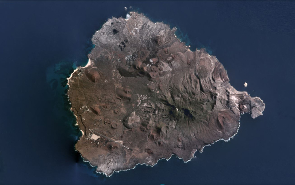 The surface of the nearly 14-km-wide Ascensión Island is composed of mafic and felsic eruptive products including scoria cones, lava flows, and pyroclastic flow deposits, some of which are seen in this July 2020 Planet Labs satellite image monthly mosaic (N is at the top). The larger, eroded edifice in the SE is Green Mountain with White Hill farther E. Numerous scoria cones with summit craters are visible across the island. Satellite image courtesy of Planet Labs Inc., 2020 (https://www.planet.com/).