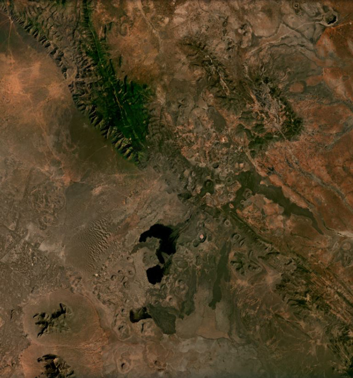 Cones, maars, lava flows, and craters of the Mega Basalt Field located along the Ethiopia-Kenya border are visible across this December 2020 Planet Labs satellite image mosaic (N at the top). It is located near the villages Mega and Megado and covers an area of approximately 1,400 km2. Large lava flows were produced from scoria cones and spatter ramparts, and the largest Maar is El Sod (top right), reaching 2.3 km in diameter and 0.41 km deep. Satellite image courtesy of Planet Labs Inc., 2020 (https://www.planet.com/).