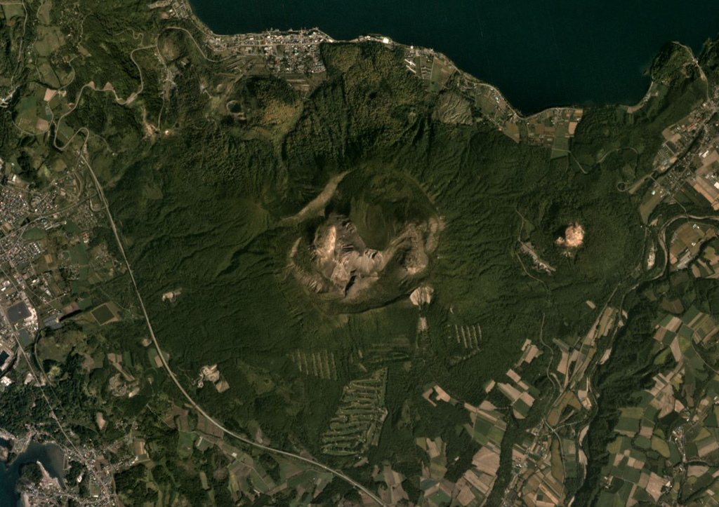 Usu formed along the SW boundary of Toya caldera and is shown in this September 2019 Planet Labs satellite (N is at the top). There is a 2-km-wide crater at the top, and within that crater and on the flanks are a scoria cone, three lava domes, and more than ten cryptodomes. Flank collapse possibly occurred around 8-7 ka, emplacing a debris avalanche deposit to the south. Satellite image courtesy of Planet Labs Inc., 2019 (https://www.planet.com/).