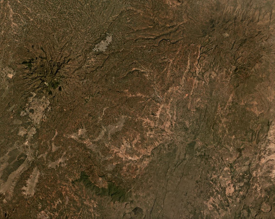 Hobitcha is a 10-km-diameter horseshoe-shaped caldera N of Lake Abaya in Ethiopia. The irregular northern caldera walls are the narrow vegetated slopes in the top of the image, and a portion of the southern wall is the narrow vegetated slope in the lower center (not the wider vegetated area) in this April 2021 Planet Labs satellite image monthly mosaic (N is at the top; this image is approximately 21 km across). Satellite image courtesy of Planet Labs Inc., 2019 (https://www.planet.com/).